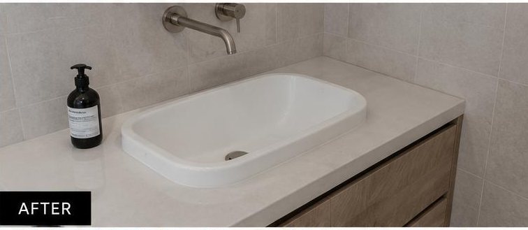 The same bathroom vanity and basin after cleaning by Fresco — stone and basin restored to white